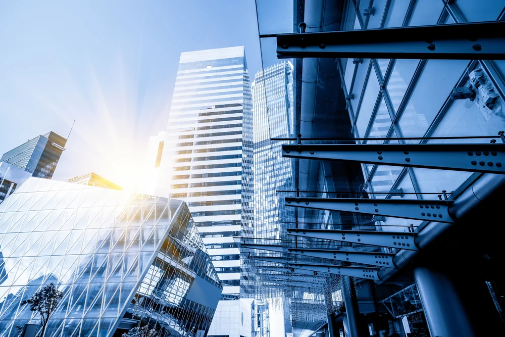 Sunlight streaming across a modern glass building, harmonising structure and light